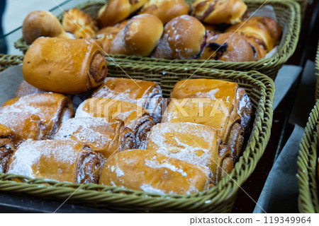 Fresh bake cinnamon roll with custard on a store counter.  119349964