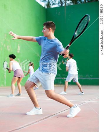 Emotional guy playing frontenis on open court on summer day 119349989