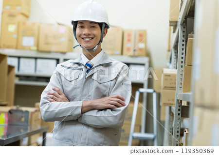 A man managing luggage in a warehouse A man managing luggage in a warehouse 119350369