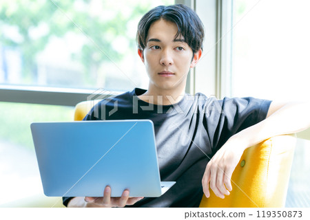 A young man with a computer A young man with a computer 119350873
