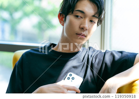 A young man with a smartphone 119350918