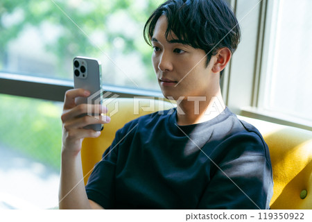 A young man with a smartphone A young man with a smartphone 119350922