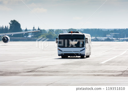 Airport shuttle bus on the main taxiway Airport shuttle bus on the main taxiway 119351810