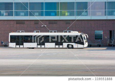 Airport shuttle bus and luggage carts near the terminal 119351888