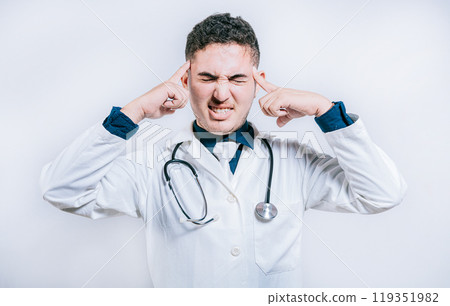 Doctor with migraine holding his head. Fatigued doctor with headache isolated, Young Doctor with headache isolated Doctor with migraine holding his head. Fatigued doctor with headache isolated, Young Doctor with headache isolated 119351982