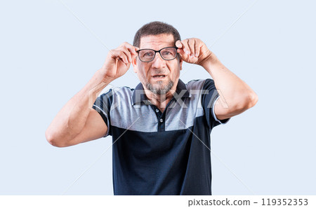 Surprised senior man taking off glasses looking at camera. Amazed senior man taking off glasses isolated Surprised senior man taking off glasses looking at camera. Amazed senior man taking off glasses isolated 119352353