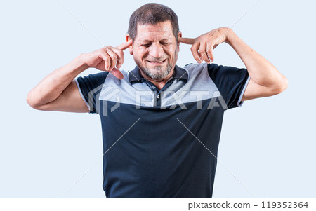 Displeased senior man covering his ears isolated. Older people ignoring and covering ears 119352364