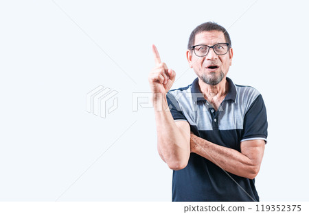 Shocked old man in glasses pointing at a advertising up. Surprised elderly man pointing up Shocked old man in glasses pointing at a advertising up. Surprised elderly man pointing up 119352375