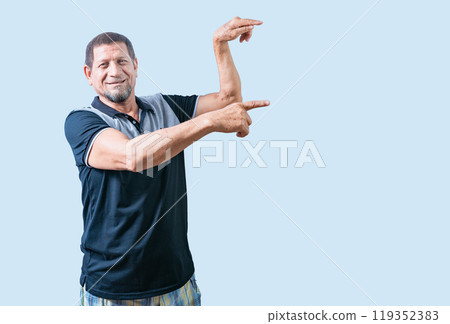 Happy senior man pointing at an advertising space isolated. Smiling senior man pointing to the side isolated Happy senior man pointing at an advertising space isolated. Smiling senior man pointing to the side isolated 119352383