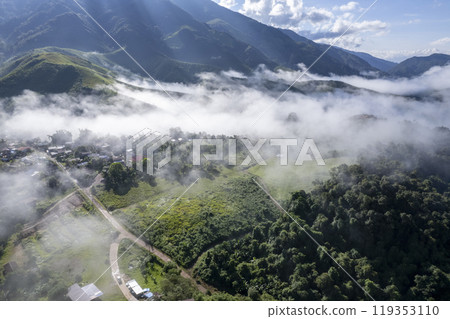 Landscape of Morning Mist with Mountain Layer at north of chiang rai Thailand. mountain ridge and clouds in rural jungle bush forest Landscape of Morning Mist with Mountain Layer at north of chiang rai Thailand. mountain ridge and clouds in rural jungle bush forest 119353110