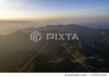 Landscape of Morning Mist with Mountain Layer at north of chiang rai Thailand. mountain ridge and clouds in rural jungle bush forest Landscape of Morning Mist with Mountain Layer at north of chiang rai Thailand. mountain ridge and clouds in rural jungle bush forest 119353128