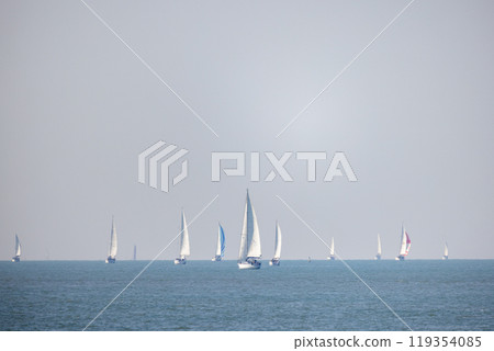 Sailing Vessels Gracefully Gliding on the Calm and Tranquil Ocean Waters at Daylight 119354085