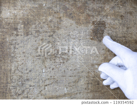restoration and conservation of a very old canvas, restoration of a painting, restorer at work, place for text 119354592