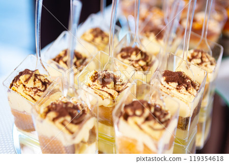 Delicious Layered Desserts in Clear Cups Displayed at a Festive Celebration Event Delicious Layered Desserts in Clear Cups Displayed at a Festive Celebration Event 119354618
