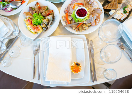 Elegant Dining Setup Featuring an Array of Gourmet Dishes at a Festive Celebration Elegant Dining Setup Featuring an Array of Gourmet Dishes at a Festive Celebration 119354628