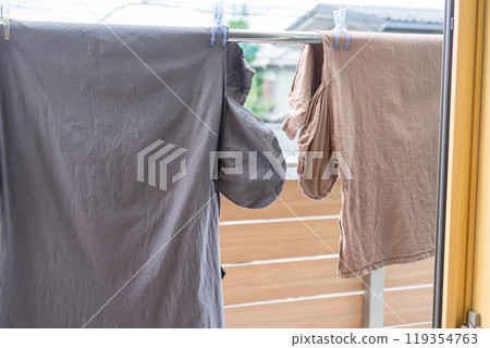Hanging a dress loosely on a clothesline Hanging a dress loosely on a clothesline 119354763