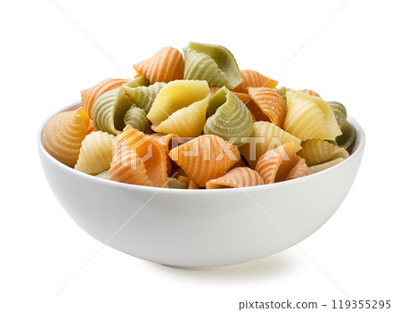 Colored pasta in a plate close-up on a white. Isolated 119355295
