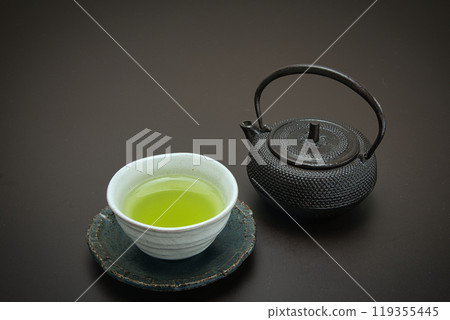 Japanese tea poured into an iron teapot and teacup Japanese tea poured into an iron teapot and teacup 119355445