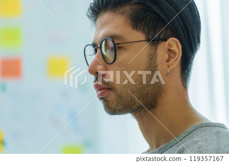 Asian man  prompt engineer develop coding app with software data sitting in front of computer monitor at office 119357167