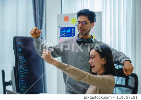 asian and Indian Developer team clapping hand for project success  with software computer at office 119357181
