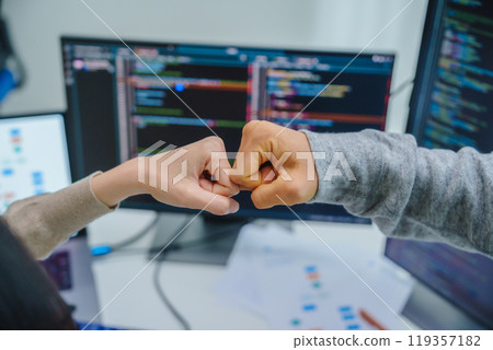 asian and Indian Developer team clapping hand for project success  with software computer at office 119357182