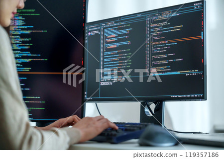 Asian man  prompt engineer develop coding app with software data sitting in front of computer monitor at office 119357186