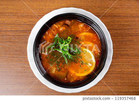 Russian soup Solyanka on wooden table side view 119357468