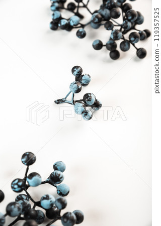 Artificial berries on a wire for needlework and decoration of gifts, wreaths on white background Artificial berries on a wire for needlework and decoration of gifts, wreaths on white background 119357525