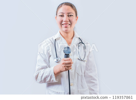 Young female doctor holding tensiometer on isolated background. Smiling female doctor showing blood pressure monitor isolated 119357861