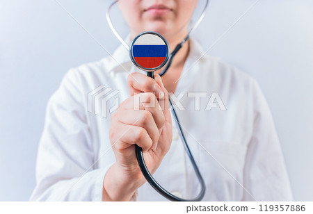Female doctor holding stethoscope with with Russia flag. Russia health and care concept Female doctor holding stethoscope with with Russia flag. Russia health and care concept 119357886