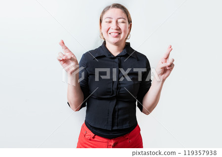 Smiling hopeful girl making a wish with her fingers isolated. Beautiful smiling girl crossing fingers making a wish Smiling hopeful girl making a wish with her fingers isolated. Beautiful smiling girl crossing fingers making a wish 119357938