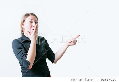 surprised young woman pointing an advertising isolated. Beautiful woman pointing to a banner to the side. Funny people pointing a promo isolated surprised young woman pointing an advertising isolated. Beautiful woman pointing to a banner to the side. Funny people pointing a promo isolated 119357939