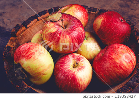apples in a wooden bowl, top view, yellow - red, summer variety, early, no people, 119358427