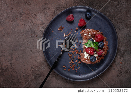 half-eaten chocolate tartlet, on a plate, stuffed with cottage cheese and berries, breakfast, homemade, no people, half-eaten chocolate tartlet, on a plate, stuffed with cottage cheese and berries, breakfast, homemade, no people, 119358572