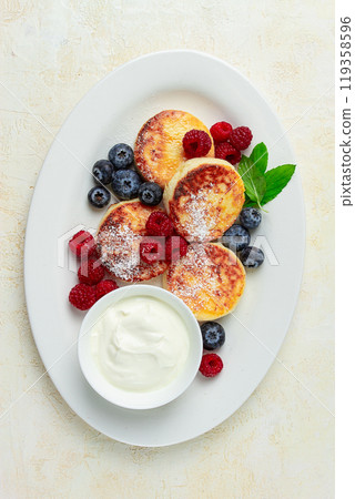 breakfast, cottage cheese cakes, with fresh berries, and sour cream, top view, close-up, no people, breakfast, cottage cheese cakes, with fresh berries, and sour cream, top view, close-up, no people, 119358596