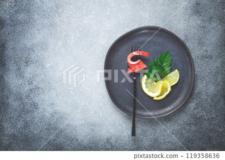 chum salmon, cold smoked, on a fork, with lemon and parsley, top view, close-up, no people, chum salmon, cold smoked, on a fork, with lemon and parsley, top view, close-up, no people, 119358636