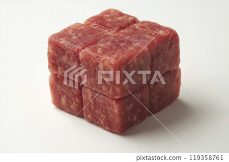 A stack of raw beef cubes arranged into a larger cube, placed on a white background 119358761