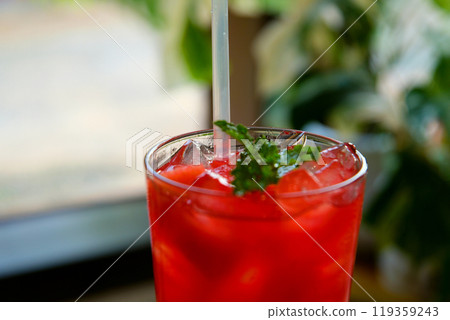Fresh watermelon juice or smoothie in glasses with watermelon pieces on pink background. Refreshing summer drink 119359243