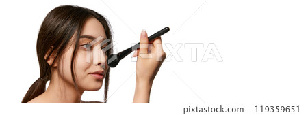 Portrait of beautiful, young Korean girl with well-kept spotless skin, doing her nude makeup, using brush for powder. Banner Portrait of beautiful, young Korean girl with well-kept spotless skin, doing her nude makeup, using brush for powder. Banner 119359651