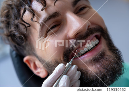 Unknown dentist doing oral examination with advanced dental equipment for patient Unknown dentist doing oral examination with advanced dental equipment for patient 119359662