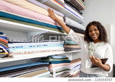 Woman dressmaker shopping selects cloths using technology to browse and buy from the online catalog 119359707