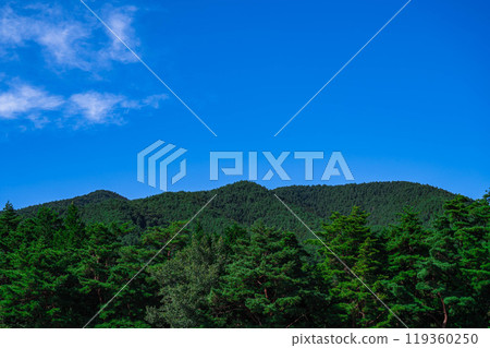 Coniferous trees, mountains and blue sky around Mount Kyogatake in the Kiso Mountains in autumn 119360250