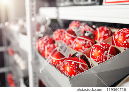 Many colorful bright festive Christmas handmade baubles toys decoration sale in boxes at factory manufacture store. Multicolored hand painted New year tree balls decor shop 119360736