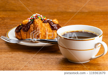 Croissant garnished with chocolate and rainbow sprinkles. Croissant garnished with chocolate and rainbow sprinkles. 119361670
