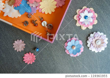 Small, colorful paper flowers for creativity of 3D flowers. Child development toy Small, colorful paper flowers for creativity of 3D flowers. Child development toy 119361955