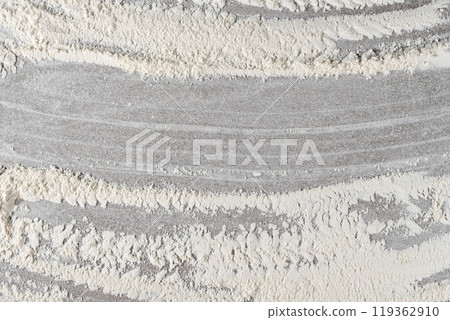 Grey cooking background of spilled wheat flour on stone background, top view. Grey cooking background of spilled wheat flour on stone background, top view. 119362910