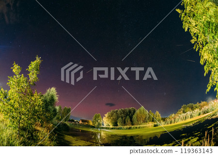 Aurora borealis Amazing Night Starry Sky above summer country landscape. Bright Dramatic Perseids meteors Trails Of Stars And Meteors. Sky In Different Colors. From Dusk Till Dawn. Misty Night. Aurora borealis Amazing Night Starry Sky above summer country landscape. Bright Dramatic Perseids meteors Trails Of Stars And Meteors. Sky In Different Colors. From Dusk Till Dawn. Misty Night. 119363143