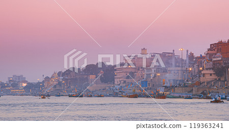 Varanasi, Uttar Pradesh, India. Many Boats Moored On Ganga River Near Ghats. Hundreds Of Tourists And Locals Come In Boats To Watch Ganga Maha Aarti Ceremony And Fire Ceremony. Purple Sunset Sky At 119363241