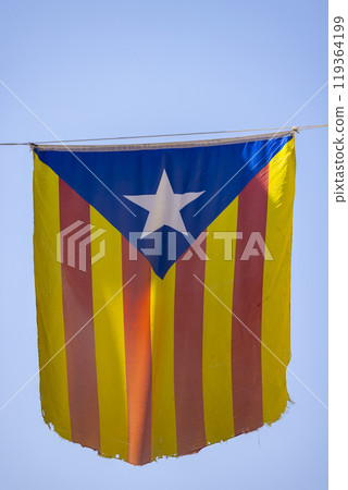 Catalan flag hanging between houses Catalan flag hanging between houses 119364199