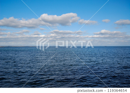 Odessa Bay of the Black Sea. Otrada Beach, on the Black Sea coast.The coastline is visible in the distance - the settlement of Kotovsky is located there. Odessa Bay of the Black Sea. Otrada Beach, on the Black Sea coast.The coastline is visible in the distance - the settlement of Kotovsky is located there. 119364654